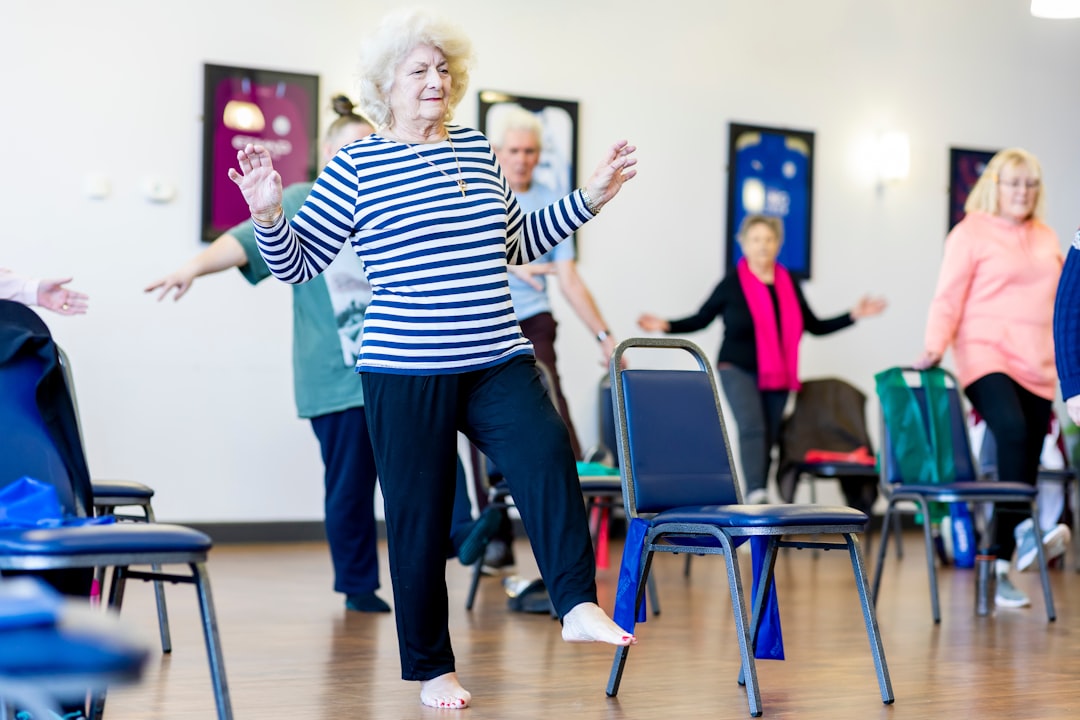 Older woman doing a seated chair exercise