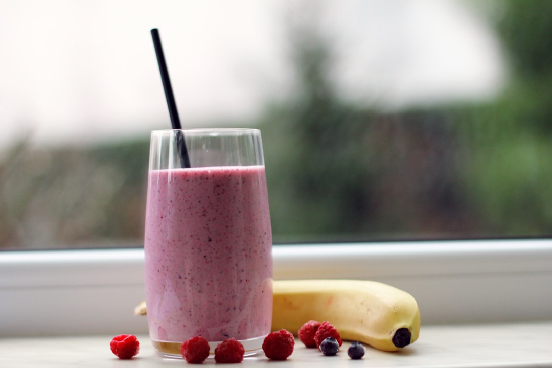 Protein smoothie in a glass on a kitchen counter