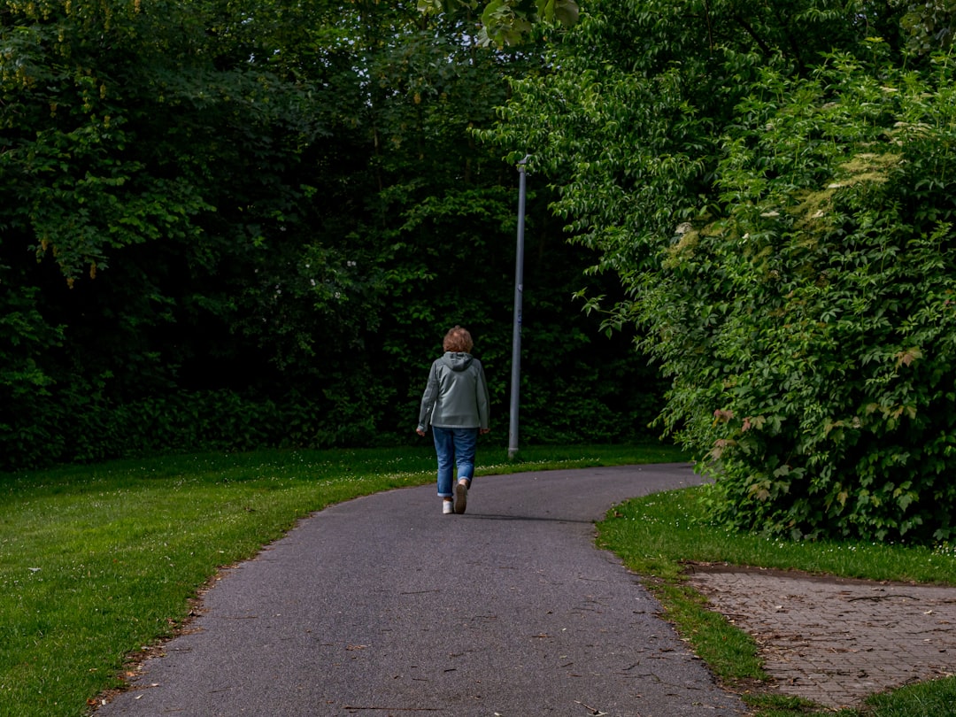 Woman walking briskly on a park path