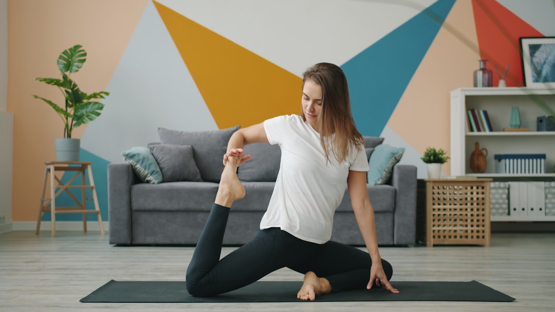 Woman exercising against a wall at home