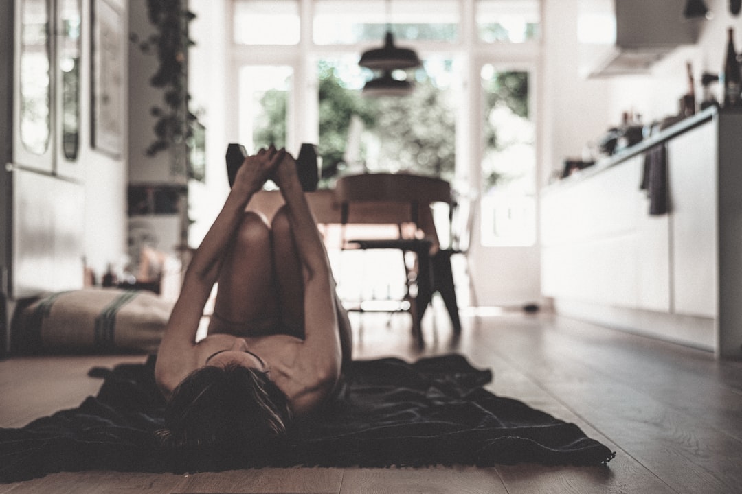 Woman lifting light dumbbells at home