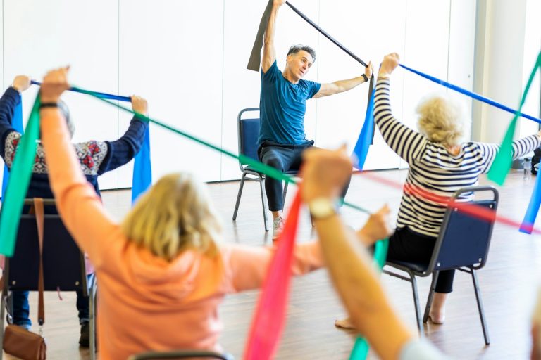 Seated exercise class using colorful resistance bands