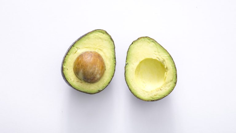 Halved avocado on a white background