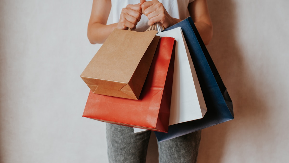 Woman holding several shopping bags in one hand