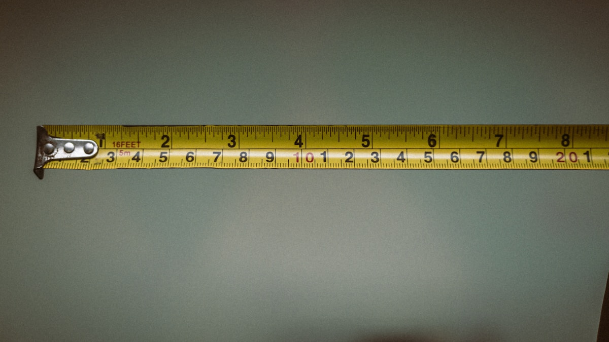 Hand holding a tape measure