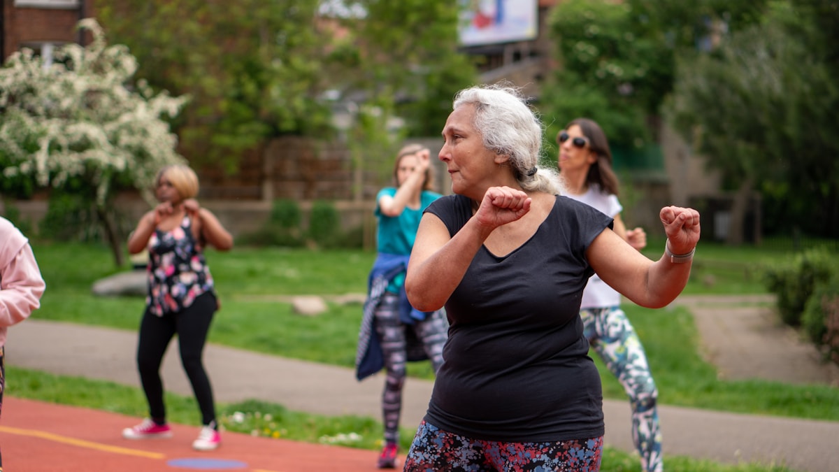 Group of older women exercising together on an outdoor track