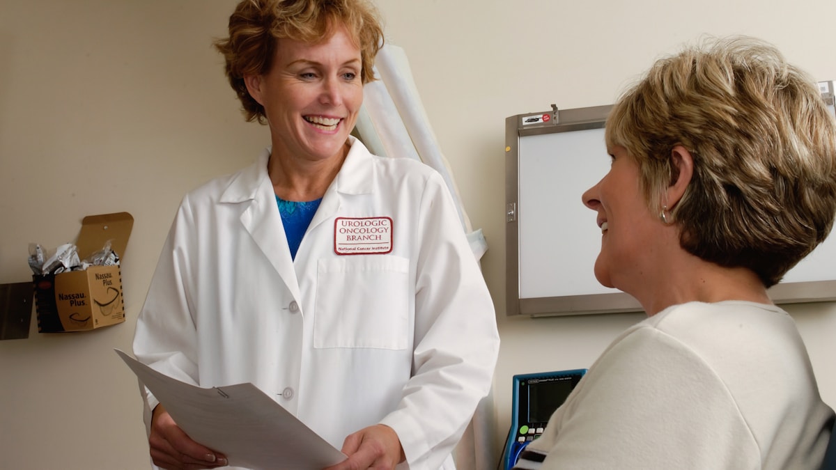 Doctor in a white coat talking with a patient