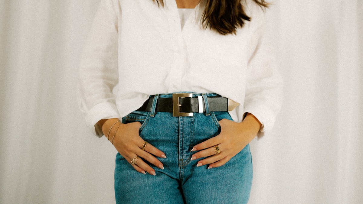 Woman in a white shirt and jeans with her hands on her waist